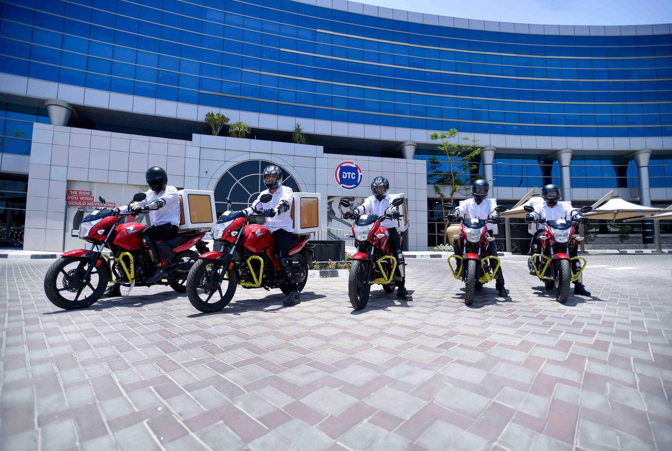 Motorcyclists working for the Dubai Taxi Company pose for a photo outside the company’s office in Dubai, UAE on May 29, 2024. (DTC)