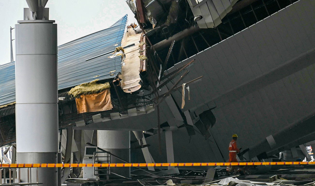 A member of National Disaster Response Force (NDRF) works at the site of collapsed terminal roof of New Delhi’s Indira Gandhi International Airport after heavy rains in New Delhi on June 28, 2024. (AFP)