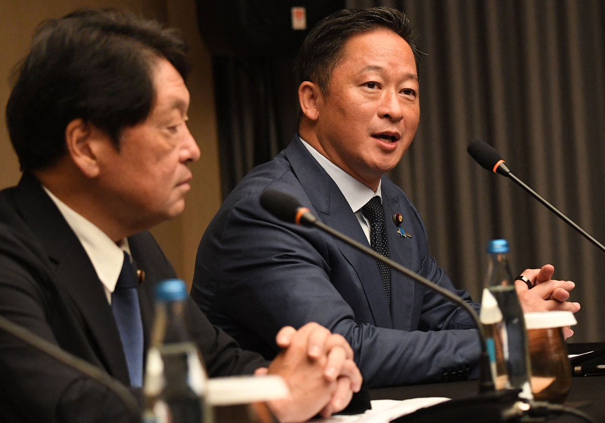 Japanese legislator Yoshiaki Wada (R) speaks while fellow legislator Itsunori Onodera listens during a press conference at a hotel in Manila on June 28, 2024. (AFP)