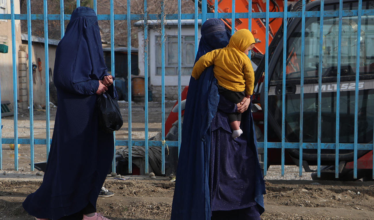 Afghan burqa-clad women walk along a roadside in the Fayzabad,Badakhshan province, on March 6, 2024. (AFP/File)