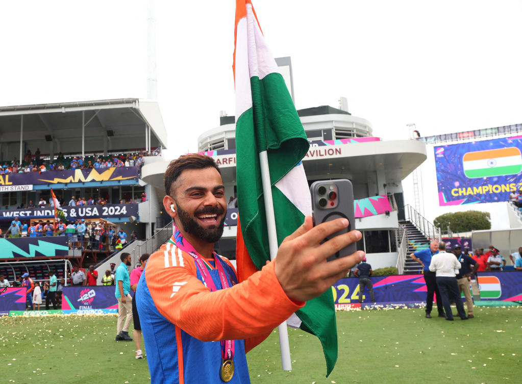 India’s Virat Kohli takes a selfie as he celebrates with a flag after winning the T20 World Cup in the final against South Africa. (Reuters)
