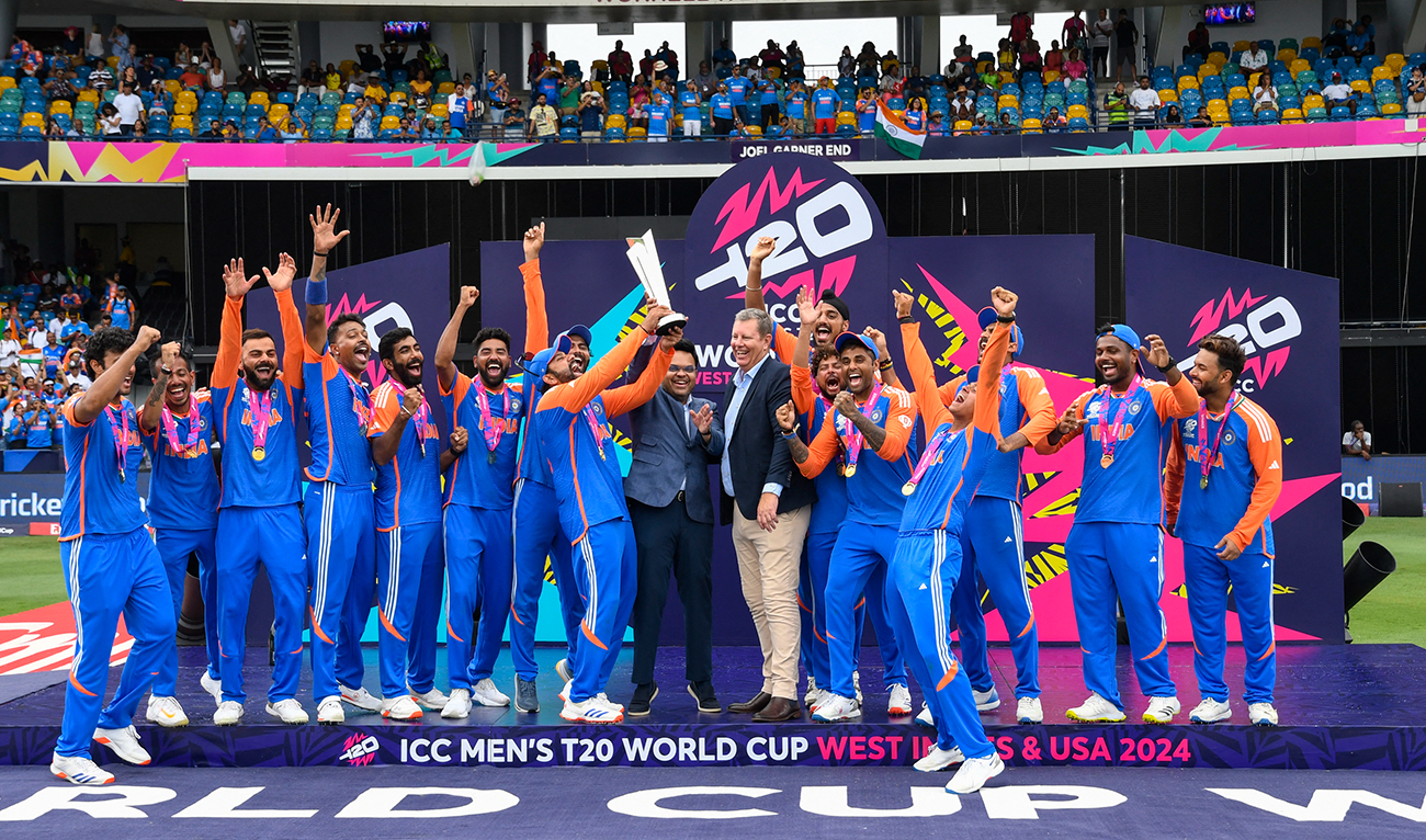 Secretary of the Board of Control for Cricket in India, Jay Shah (C L) celebrates with team India after receiving the winning trophy from Chairman of the International Cricket Council Greg Barclay (C R) during the ceremony after the ICC men's Twenty20 World Cup 2024 final cricket match between India and South Africa at Kensington Oval in Bridgetown, Barbados, on June 29, 2024. (AFP)