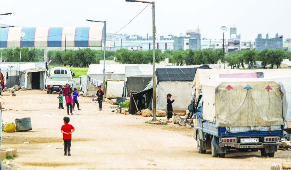 Children play outside tents at a camp for people displaced by conflict in Syria’s northern Aleppo province. The refugees face an uncertain future. (AFP file photo)