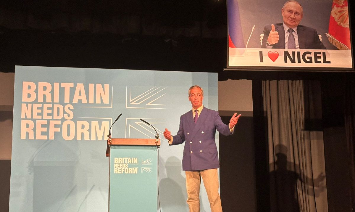 A remote-controlled screen operated by the political activist group, Led By Donkeys, lowers as Reform UK leader Nigel Farage speaks at a campaign rally at the Columbine Centre in Walton-on-the-Naze, Britain, June 29, 2024. (Reuters)