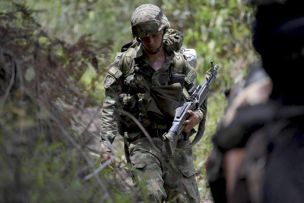 Colombian soldiers patrol in Marquetalia, the birthplace of the Revolutionary Armed Forces of Colombia (FARC), on Oct. 27, 2021. The Colombian government has been involved in peace talks with rebels to end six decades of conflict. (AFP)