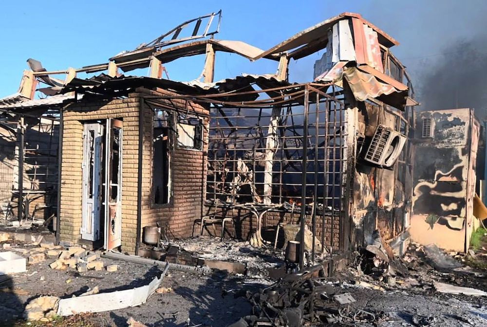 Above, a destroyed house following a Russian strike in the center of Vilniansk, Zaporizhzhia region. (Ministry of Internal Affairs of Ukraine Press Service/AFP)