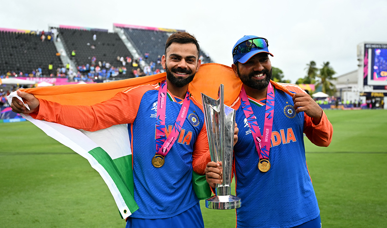 India's Virat Kohli and captain Rohit Sharma celebrate with the trophy after winning the ICC men's Twenty20 World Cup 2024 final cricket match between India and South Africa at Kensington Oval in Bridgetown, Barbados, on June 29, 2024. (AFP)