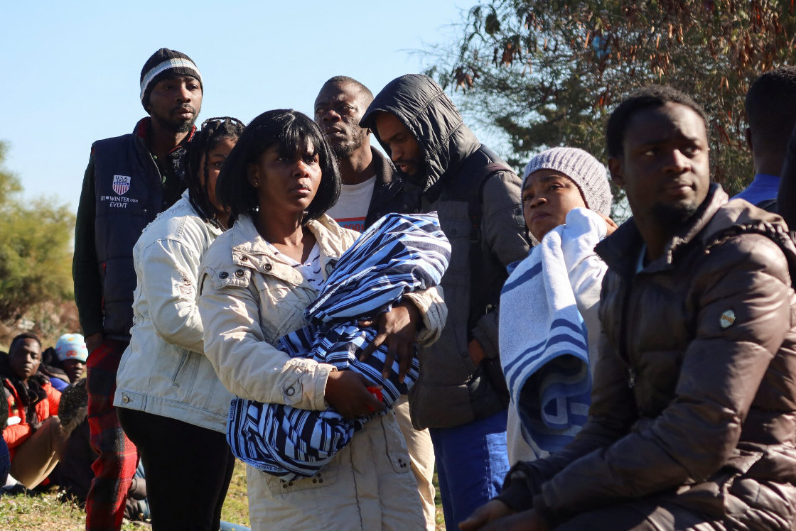 Ivory Coast nationals living in Tunisia and seeking repatriation, wait outside the embassy of Ivory Coast in Tunis. (Reuters)