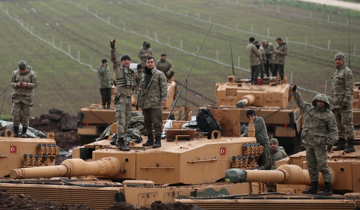 Turkish soldiers are pictured on top of their tanks near the Turkish-Syrian border in Hatay province, Turkey January 23, 2018.