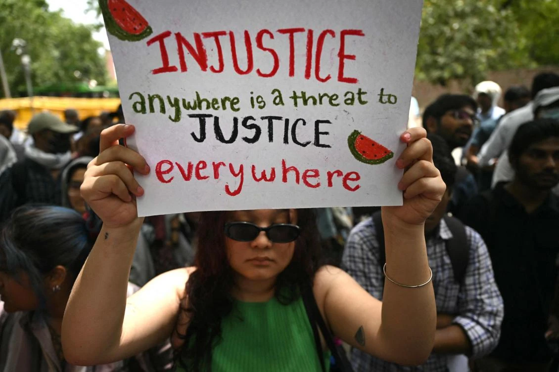 An activist holds a placard during a demonstration to express her solidarity with the Palestinians, in New Delhi amid the ongoing war between Israel and the militant Hamas group. (File/AFP)