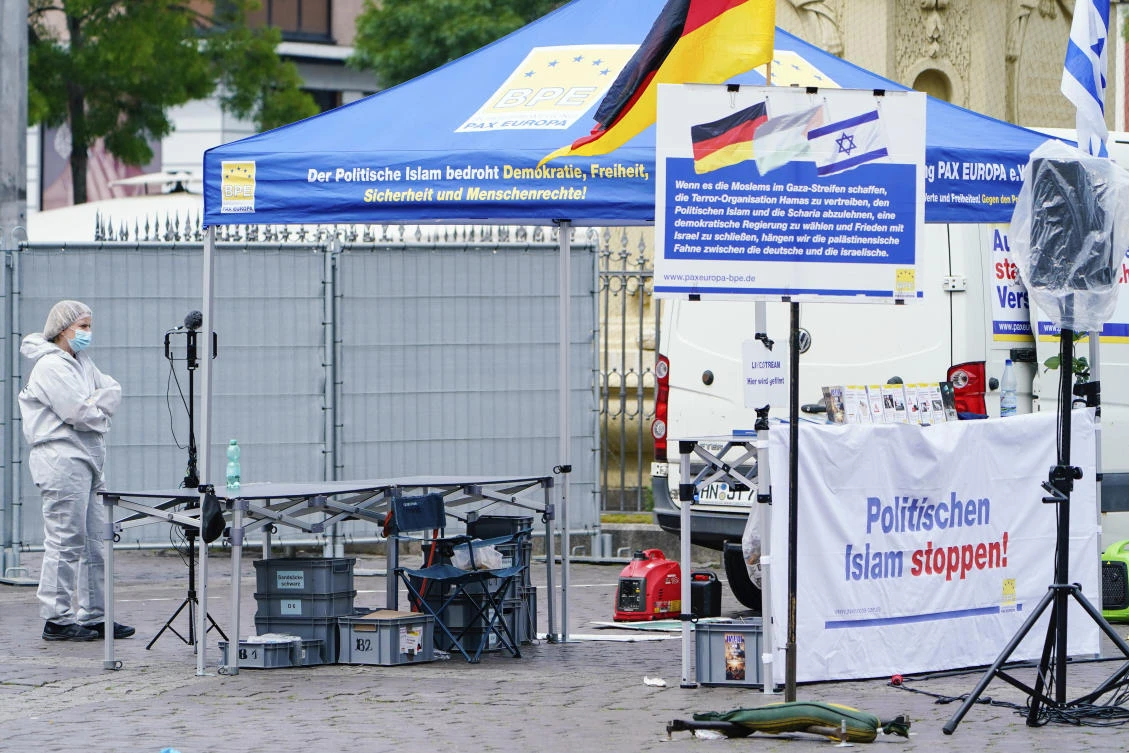 A forensic police officers walks past a smashed stall of Pax Europa which had a banner with writing reading “Stop political Islam,” on the market square in Mannheim on May 31, 2024. (AP)