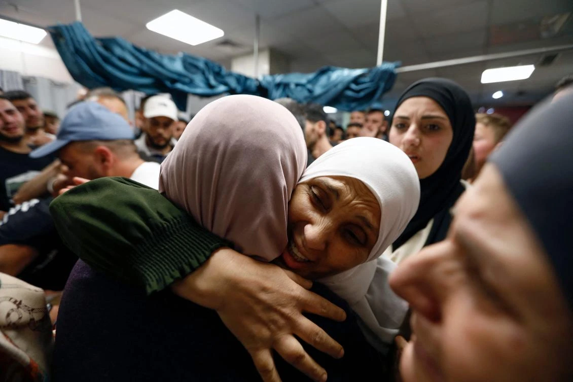 Relatives react upon seeing the body of Palestinian Wajih Ramahi at a hospital in the West Bank city of Ramallah, after he was killed in an Israeli raid on Al-Bireh, on May 30. According to local sources, Israeli forces also shot dead a Palestinian teenager in the occupied West Bank on Saturday. (AFP)