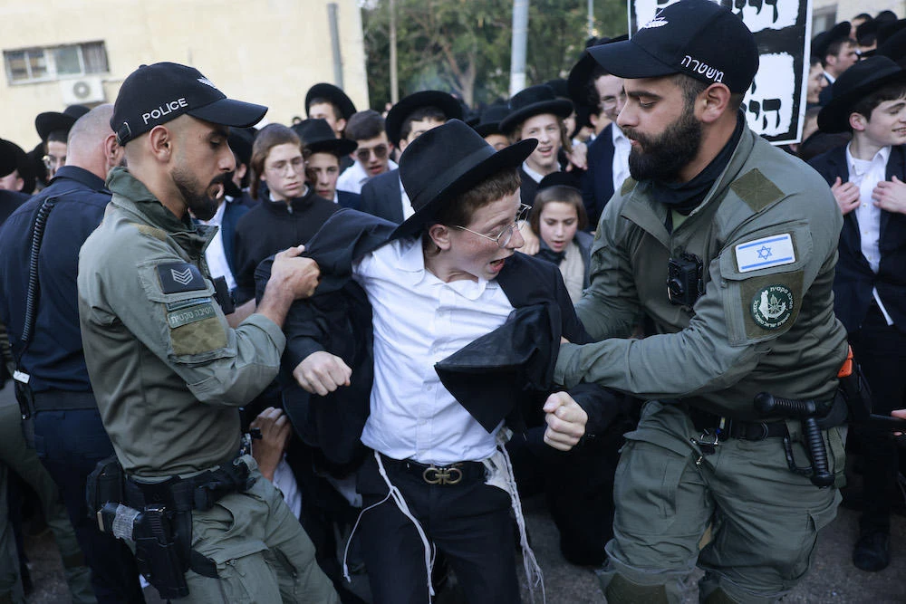 The ultra-Orthodox make up 13 percent of Israel’s population, and some claim their pious lifestyles would clash with military mores. Above, police break up ultra-Orthodox protesters in Jerusalem on April 11, 2024. (AFP)