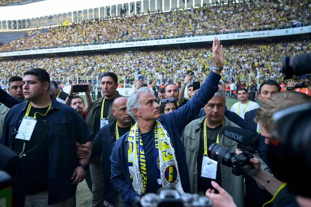 New coach of Turkish club Fenerbahce Jose Mourinho, center, during the presentation to the supporters at the Sukru Saracoglu Stadium in Istanbul on June 2, 2024. (AFP)