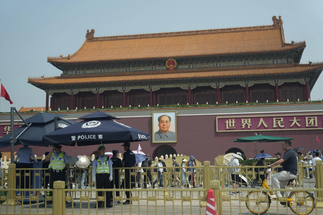Police officers watch over Tiananmen Gate in Beijing on June 4, 2024. Beijing’s toughened political stance effectively extinguished any large-scale commemorations within its borders. (AP)