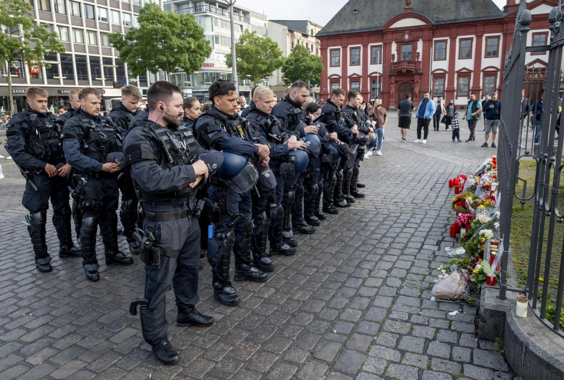 German police officers commemorate a colleague in Mannheim Germany, after learning that a police officer, who was stabbed two days ago there has died on Sunday, June 2, 2024. (AP)
