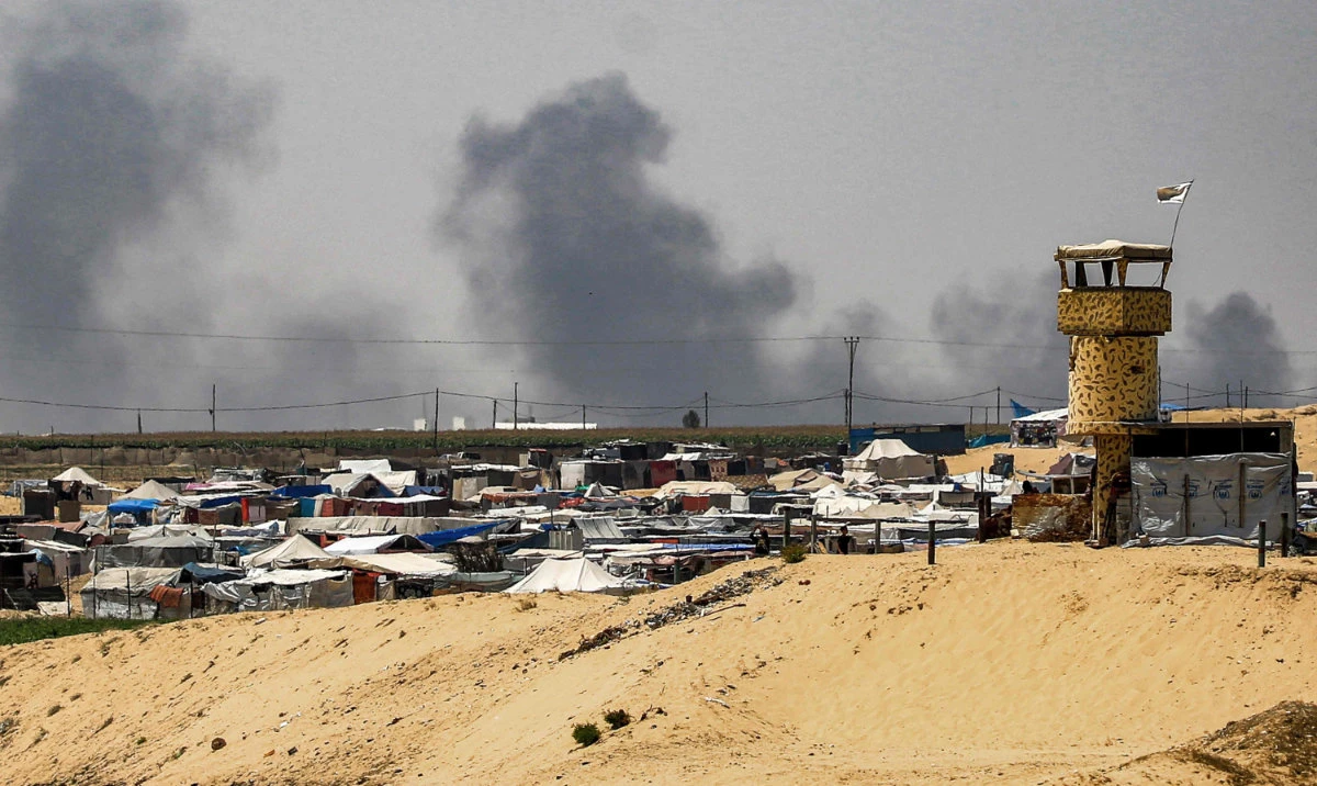 Smoke plumes billow near tents sheltering displaced Palestinians in Rafah in the southern Gaza Strip on June 4, 2024 amid the ongoing conflict in the Palestinian territory between Israel and Hamas. (AFP)