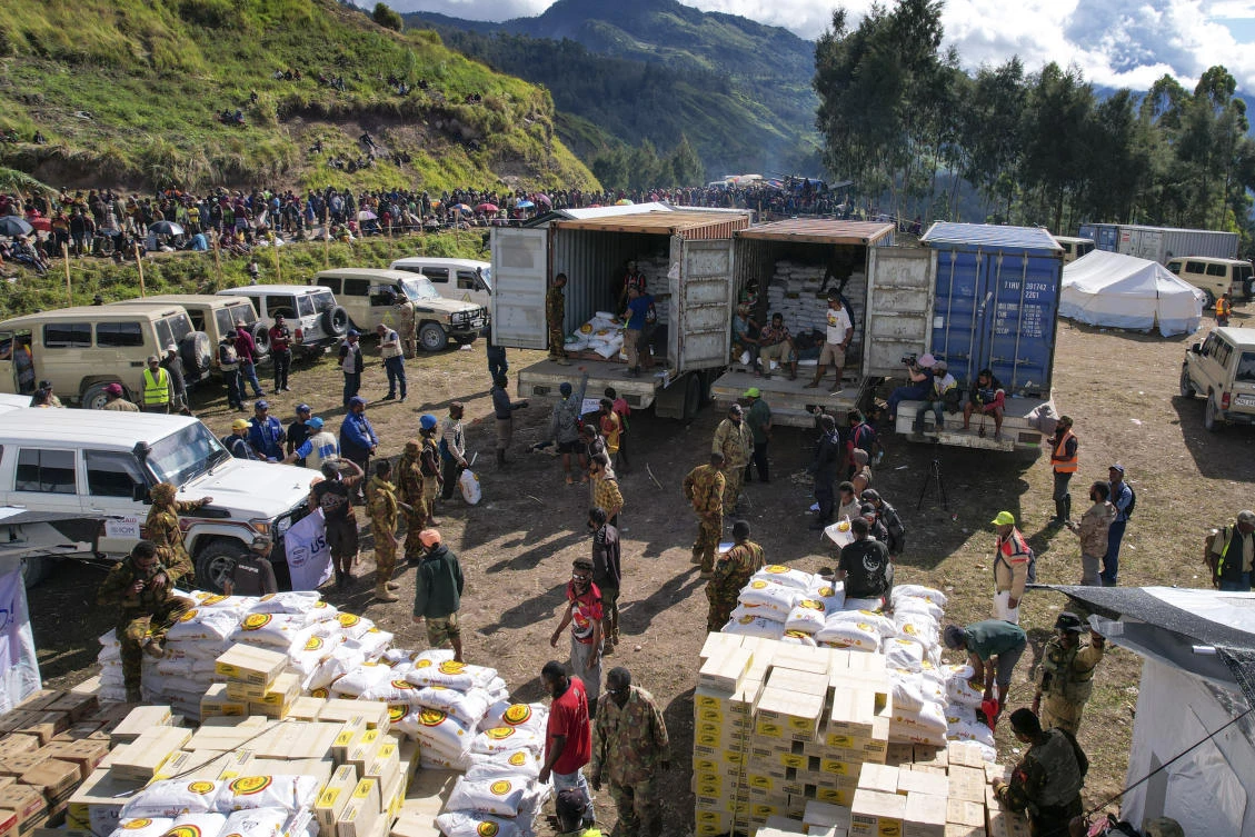 Villagers wait as food aid is distributed at a temporary site for the displaced, following the May 24 landslide near Yambali village in the highlands of Papua New Guinea, Monday, June 3, 2024. (AP)