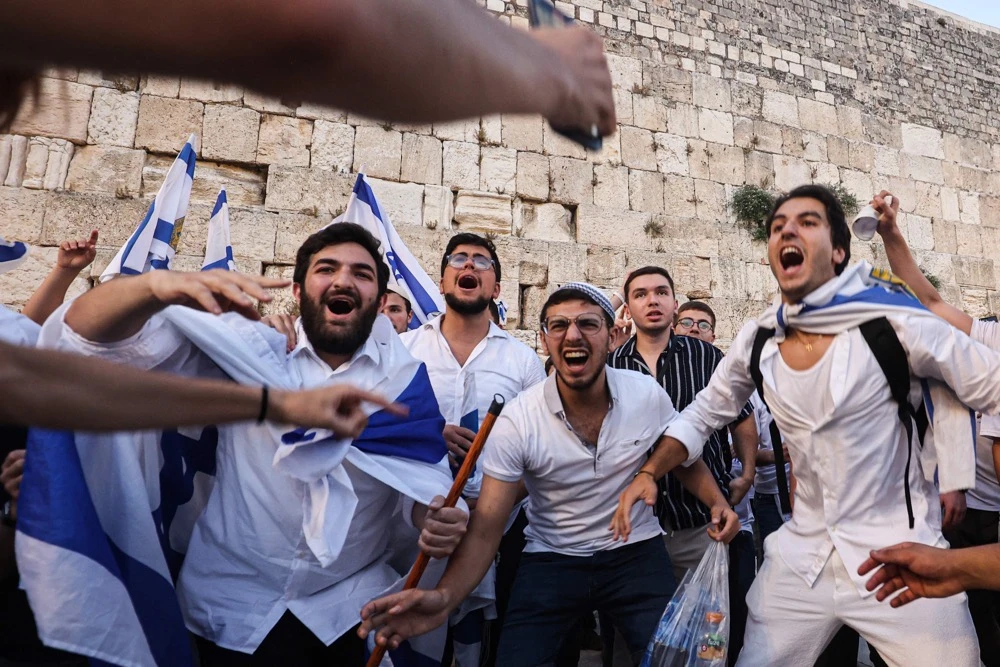 Israeli nationalists, including far-right activists, shout and dance at the Western Wall in the Old City of Jerusalem. (AFP)