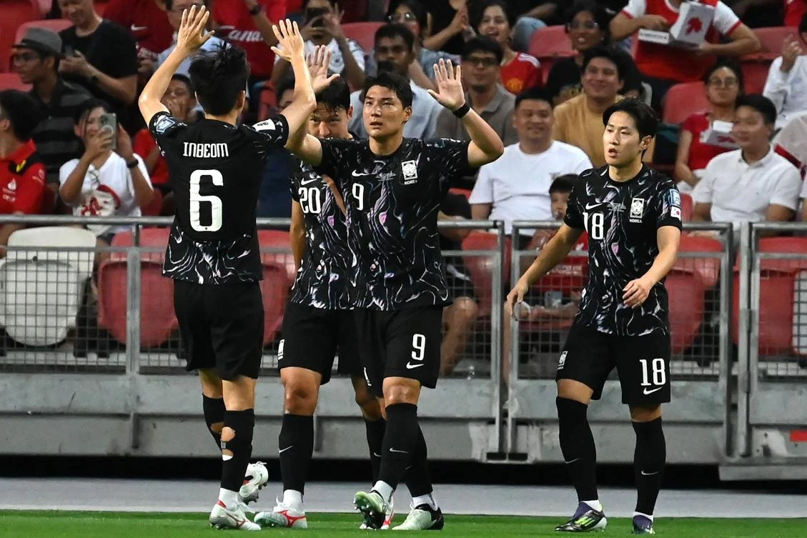 South Korea’s Joo Min-kyu (C) celebrates with teammates after scoring during their 2026 FIFA World Cup AFC qualifiers match against Singapore at the National Stadium in Singapore on Jun. 6, 2024. (AFP)