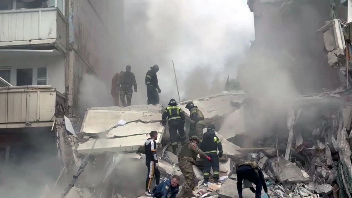 This handout photograph released on May 12, 2024, on the official Telegram account of the Belgorod region governor Vyacheslav Gladkov, shows firefighters operating on the site of an apartment building which partially collapsed after being damaged by a Ukrainian strike in Belgorod. (AFP)