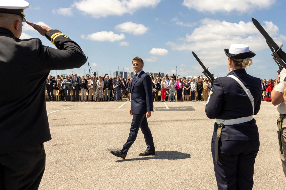 French President Emmanuel Macron reviews the troops during a commemorative ceremony in the city of Cherbourg, France. (Reuters)