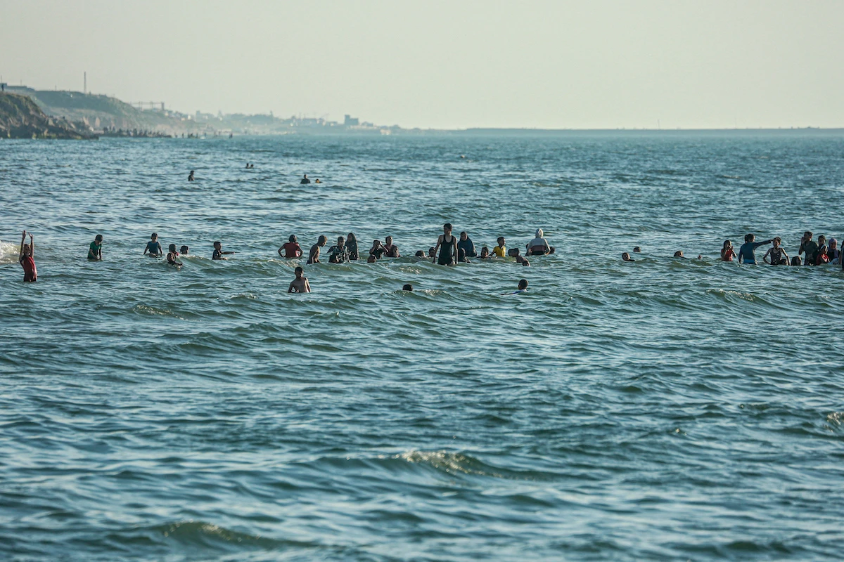 Palestinians swim in the sea in Deir el-Balah in the central Gaza Strip on April 17, 2024. (File/AFP)