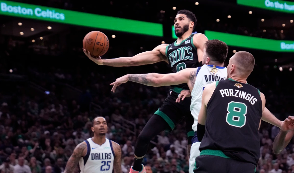 Boston Celtics forward Jayson Tatum (0) drives to the basket against Dallas Mavericks guard Luka Doncic, second from right, during the first half of Game 2 of the NBA Finals basketball series, Sunday, June 9, 2024, in Boston. (AP)
