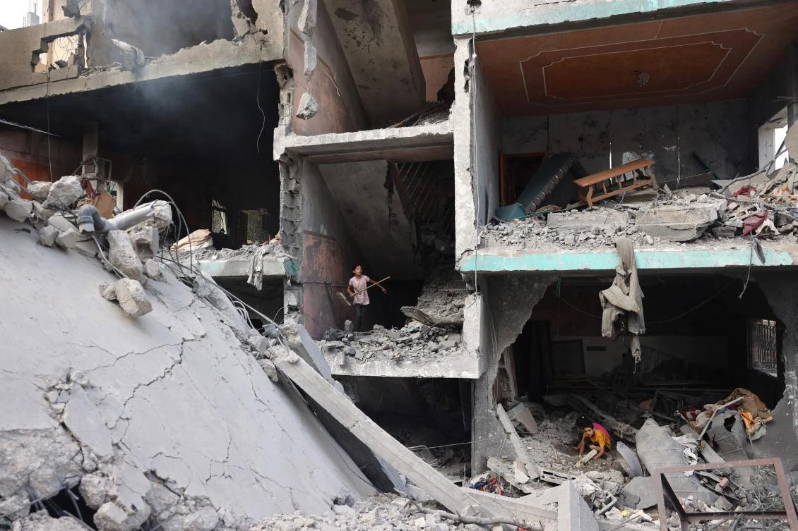 Palestinians children search through the rubble of their home a day after an operation by the Israeli military at the Nuseirat camp in the central Gaza Strip on June 9, 2024. (AFP)