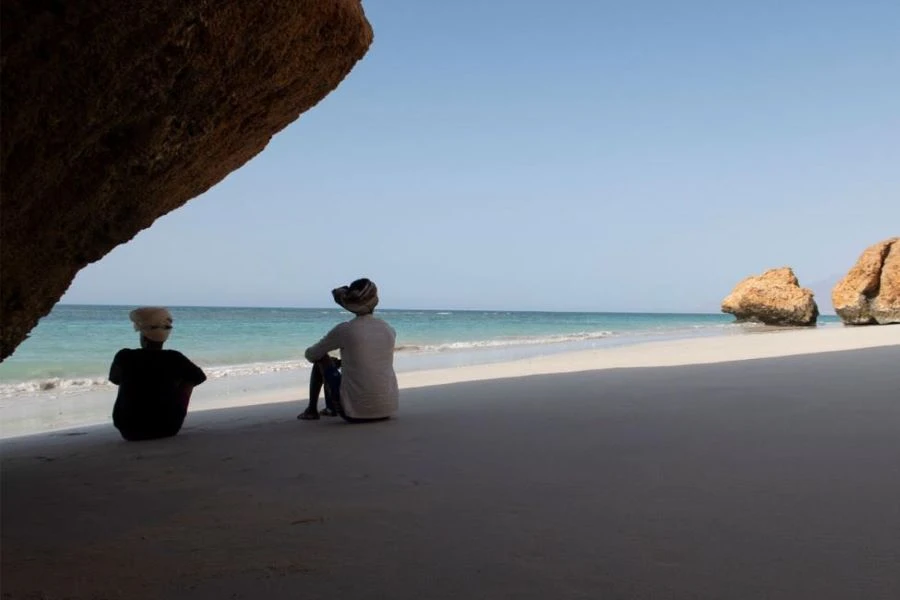 Two migrants contemplate the crossing to Yemen at a coastal location in Somalia. (IOM)