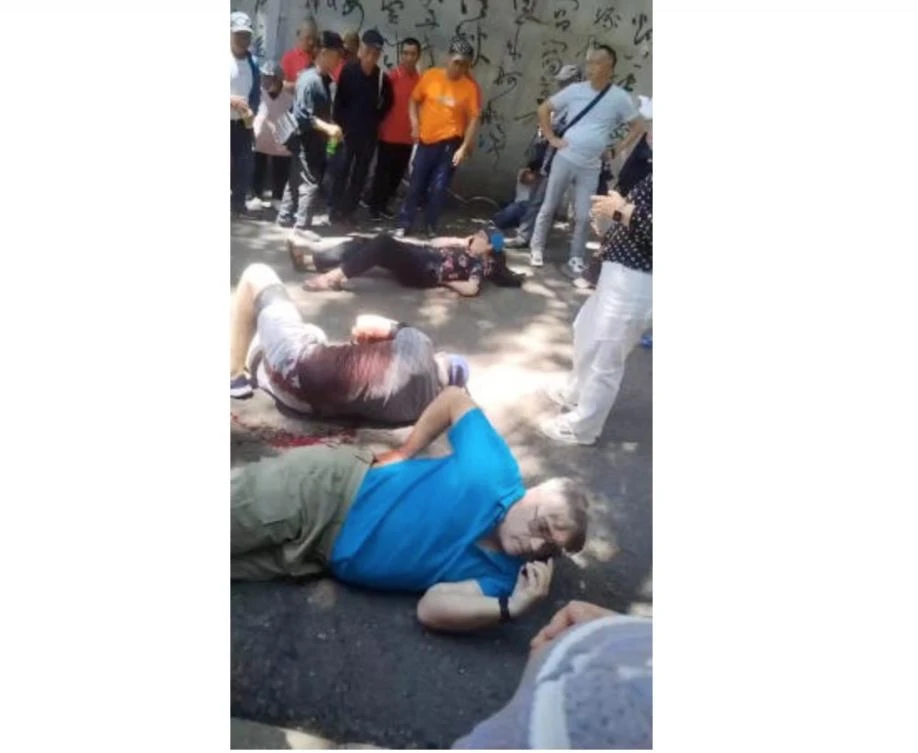 People gather around four American educators from an Iowa university, who were reportedly stabbed in a public park, according to the U.S. media and U.S. government officials, in Jilin City, Jilin province, China, in this still image taken from a video obtained by Reuters and released on June 10, 2024. (Reuters)
