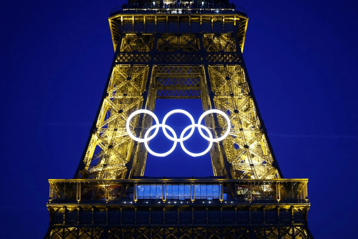 The Olympic rings are illuminated on the Eiffel Tower on June 7, 2024, ahead the upcoming Paris 2024 Olympic Games.(AFP)