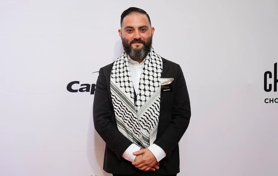 Chef Michael Rafidi of Albi in Washington, D.C., stands on the red carpet before the James Beard Awards ceremony Monday, June 10, 2024, in Chicago. Rafidi won the James Beard award for Outstanding Chef. (AP Photo/Erin Hooley)