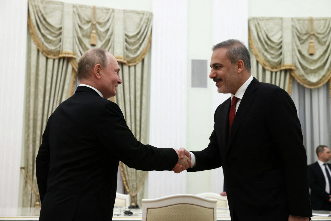 Russian President Vladimir Putin shakes hands with Turkish Foreign Minister Hakan Fidan during a meeting in Moscow on Jun. 11, 2024. (Reuters)