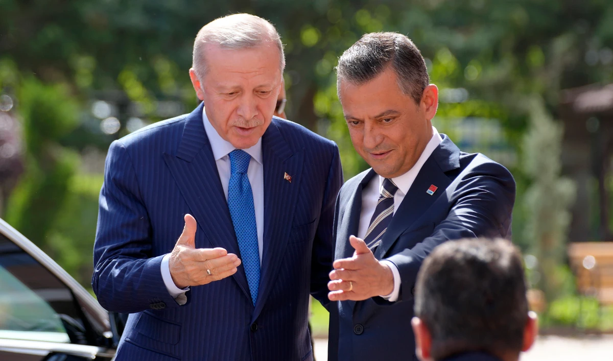 Recep Tayyip Erdogan, Turkiye’s President and leader of ruling Justice and Development Party, left, and Ozgur Ozel, the leader of main opposition Republican People’s Party, or CHP, gesture as Erdogan arrives for a meeting in Ankara, Turkey, Tuesday, June 11, 2024. (AP)