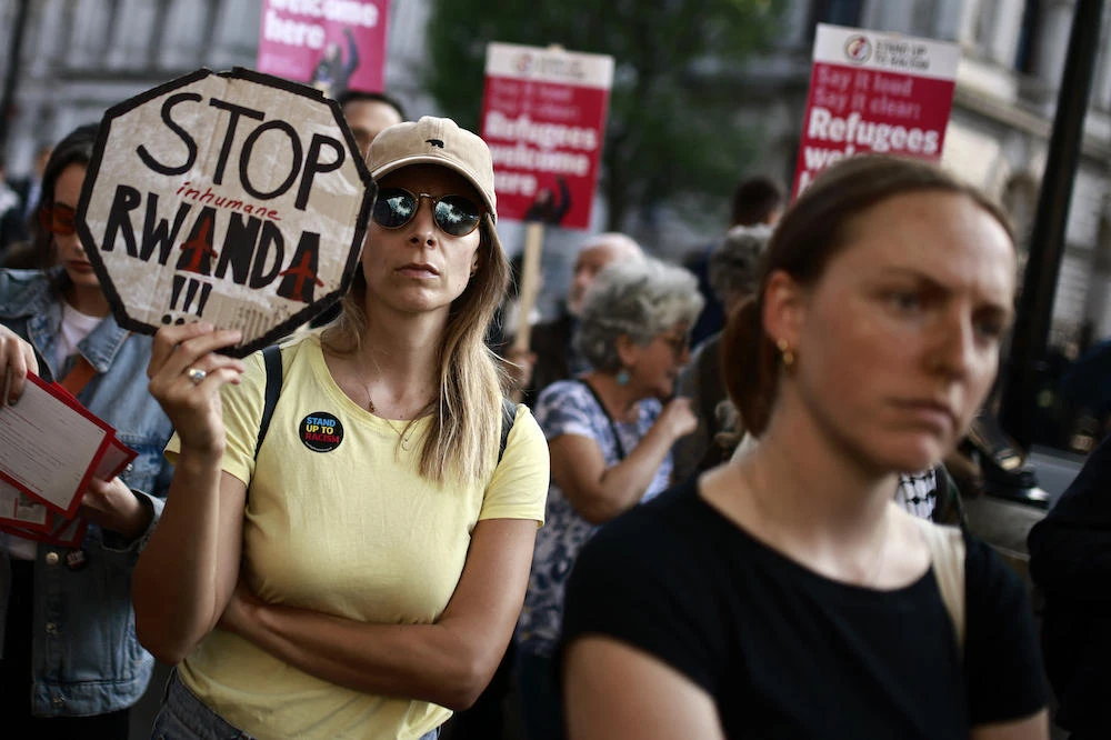 Demonstrators protest in front of 10 Downing Street in central London on May 8, 2024 to denounce the UK government’s Rwanda asylum plan. (AFP)