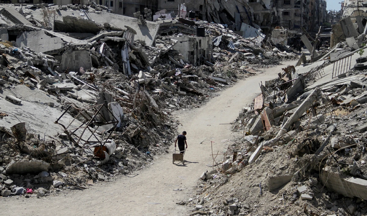A Palestinian walks among the rubble of damaged buildings, which were destroyed during Israel’s military offensive, amid the ongoing conflict between Israel and Hamas, in Beit Lahia in the northern Gaza Strip, June 12, 2024. (REUTERS)