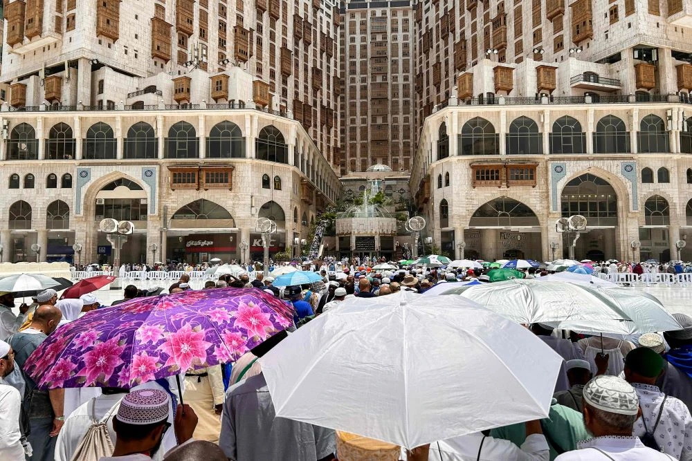 Muslim worshippers shade themselves with umbrellas as they walk near the Grand Mosque in Saudi Arabia’s holy city of Makkah on June 13, 2024, ahead of the annual Hajj pilgrimage. (AFP)