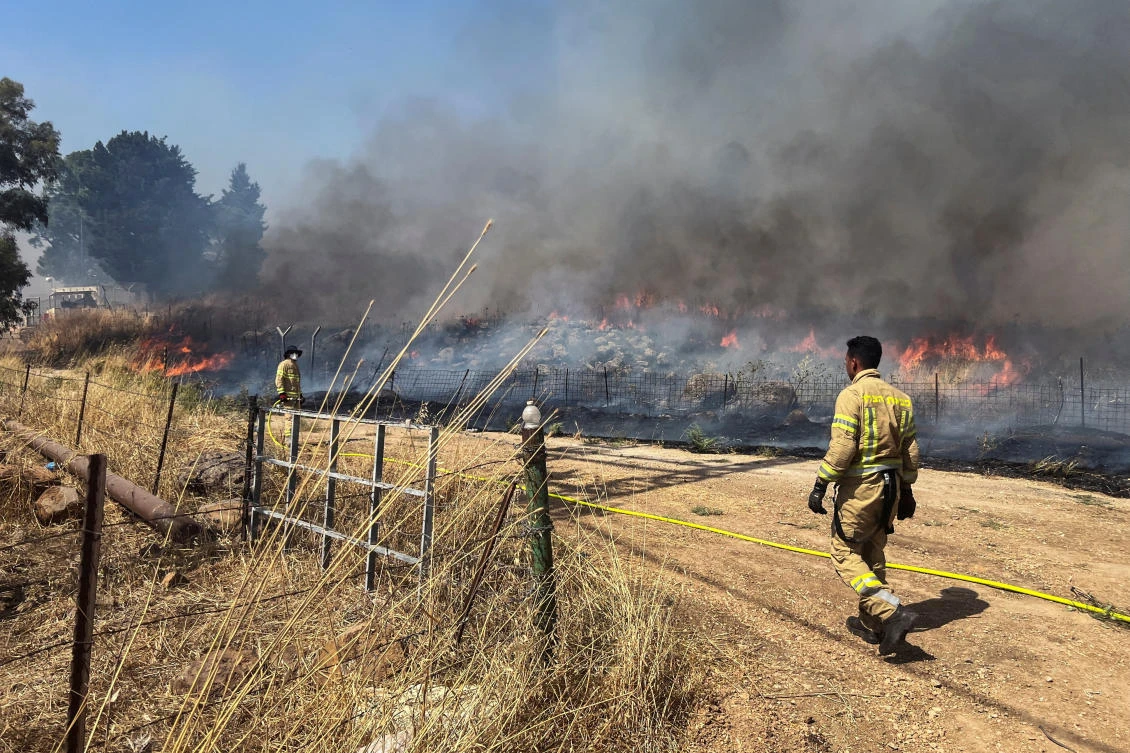 Israeli firefighters work following rocket attacks from Lebanon, amid ongoing cross-border hostilities between Hezbollah and Israeli forces, near the border on its Israeli side, Jun. 13, 2024. (Reuters)