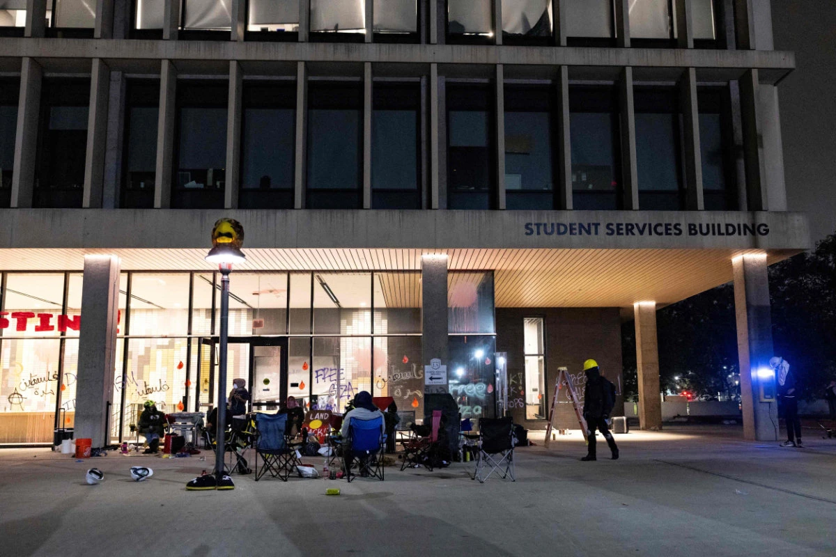 Pro-Palestinian protester block the entrance of the California State University Los Angeles (CSULA) Student Services Building in Los Angeles on June 12, 2024. (AFP)