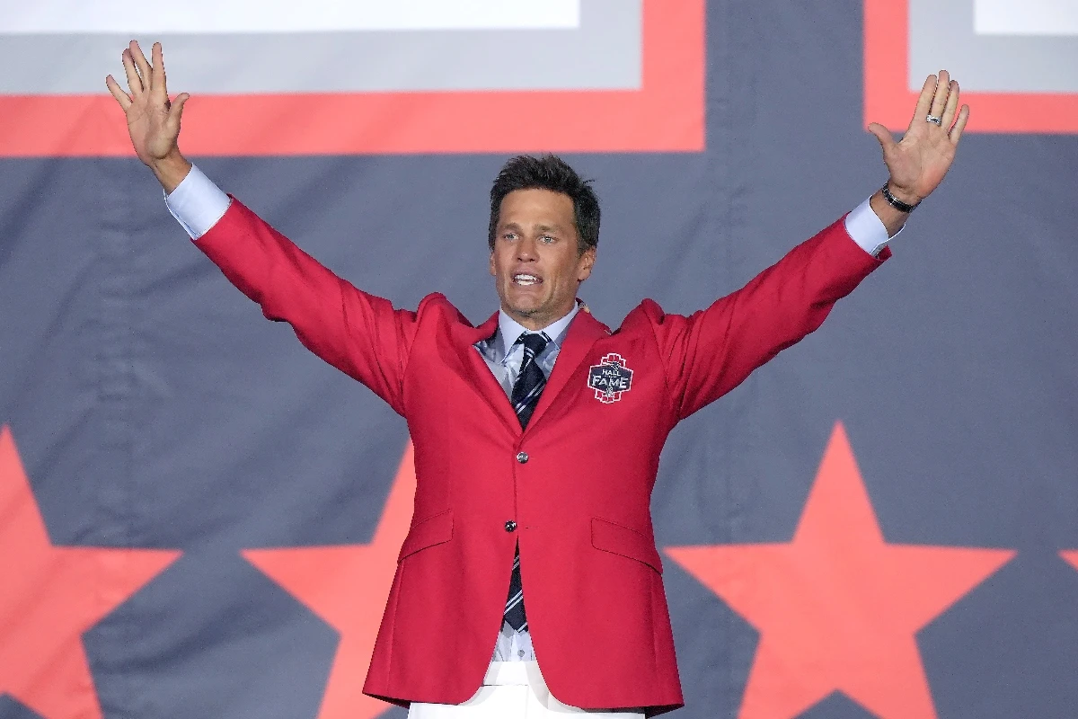 Former New England Patriots quarterback Tom Brady waves to the crowd at the conclusion of the Patriots Hall of Fame induction ceremonies for Brady at Gillette Stadium Wednesday night in Foxborough, Mass. (AP)