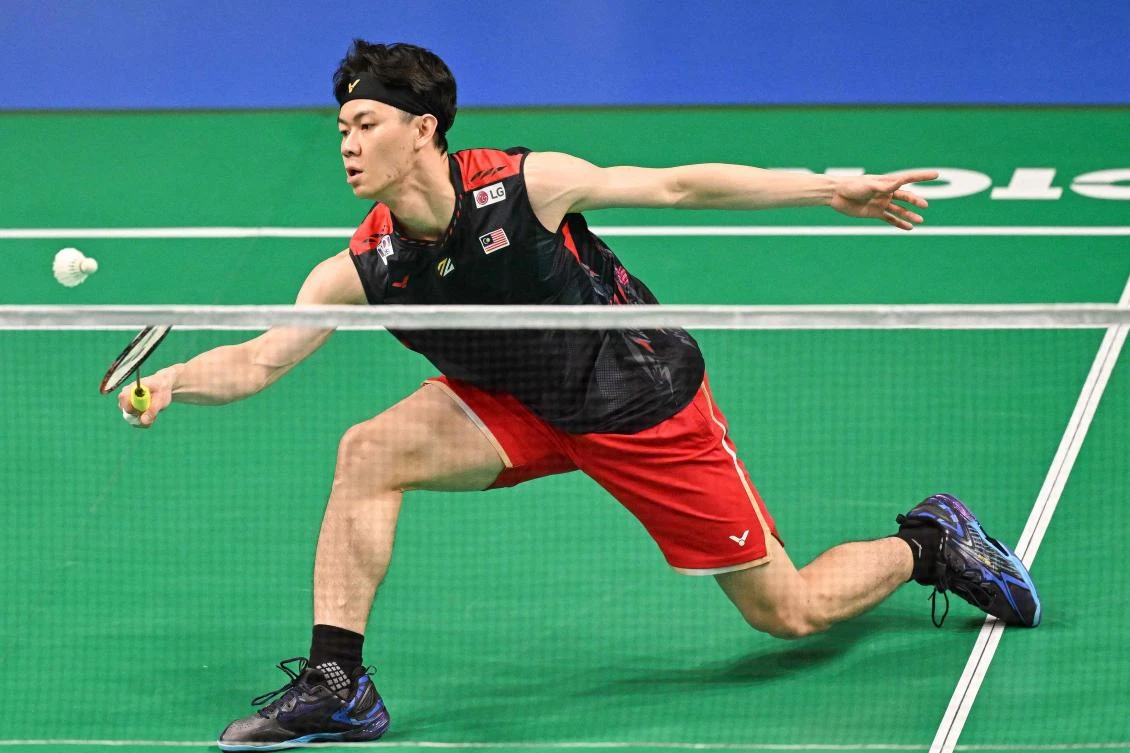 Malaysia’s Lee Zii Jia hits a return against Japan’s Kodai Naraoka during their men’s singles final match at the Australia Open badminton tournament in Sydney on June 16, 2024. (AFP)