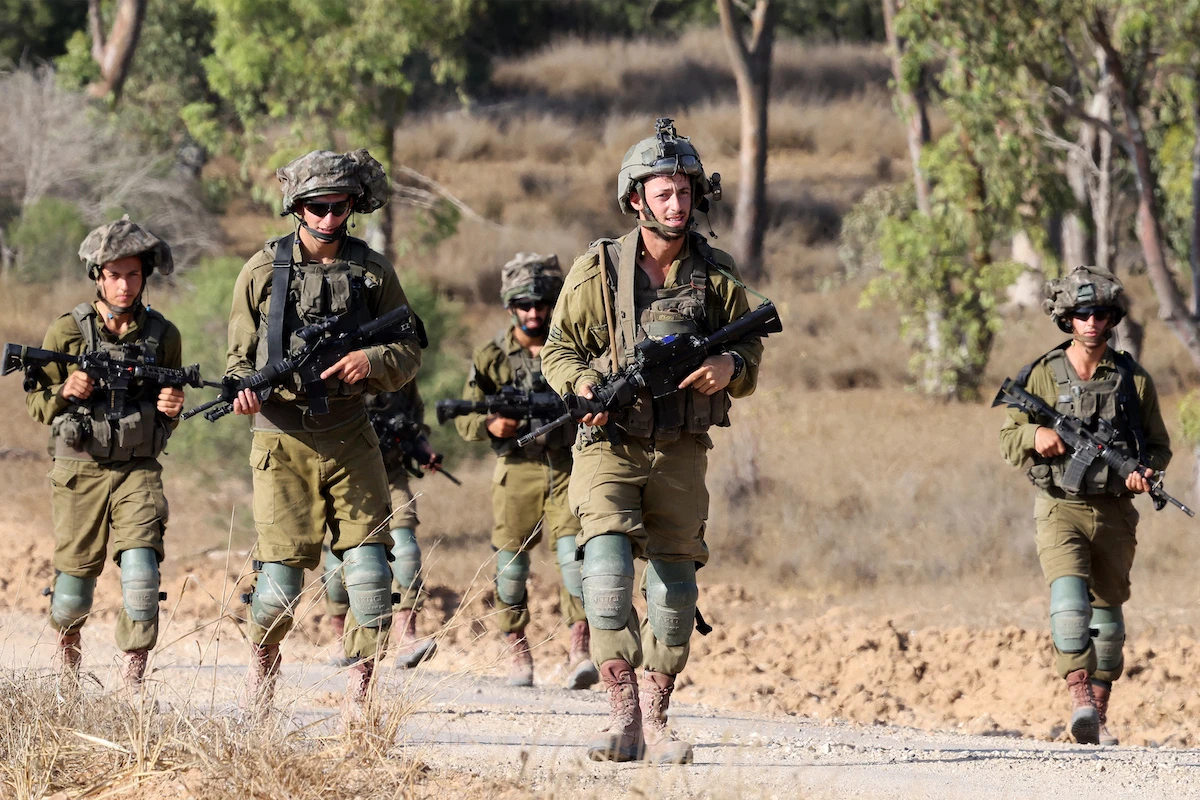 Israeli army soldiers patrol around a position along Israel's southern border with the Gaza Strip on June 13, 2024. (File/AFP)