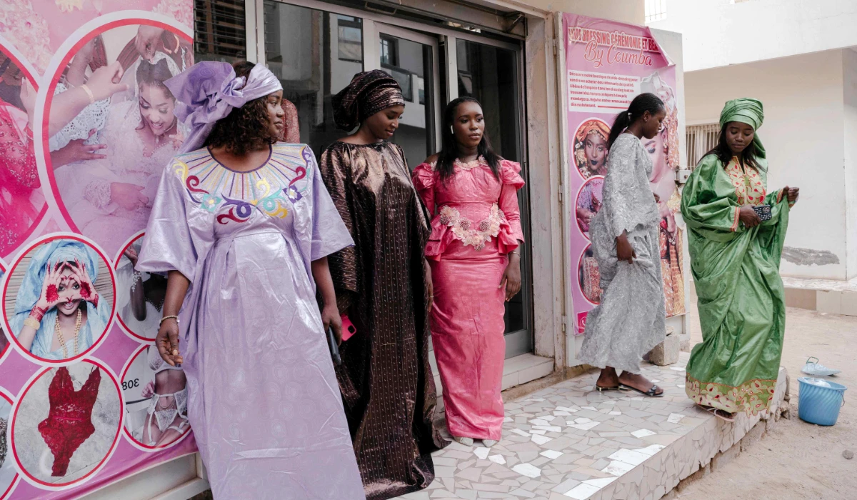Women are seen outside the boutique during a photoshoot for a second-hand shop in Rufisque, on the outskirts of Dakar on June 6, 2024. (AFP)