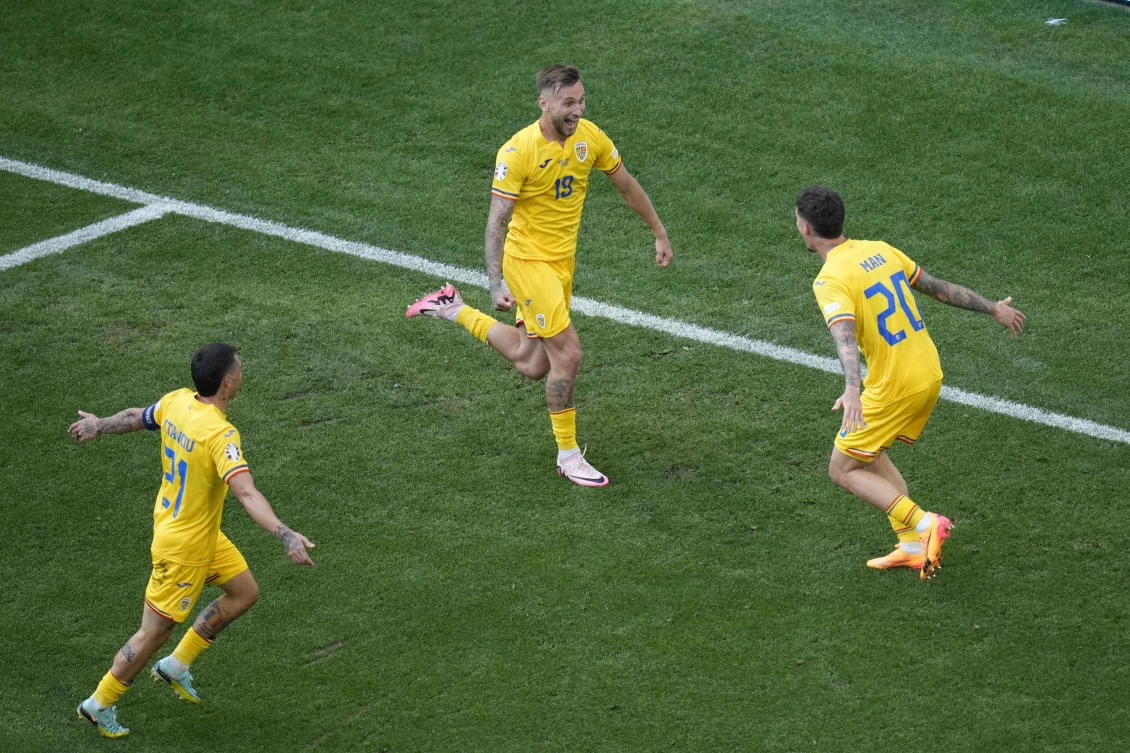 Romania’s Denis Dragus, center, celebrates with his teammates Dennis Man, right, and Nicolae Stanciu, left, after scoring the third goal against Ukraine during a Group E match at the Euro 2024 tournament in Munich. (AP)
