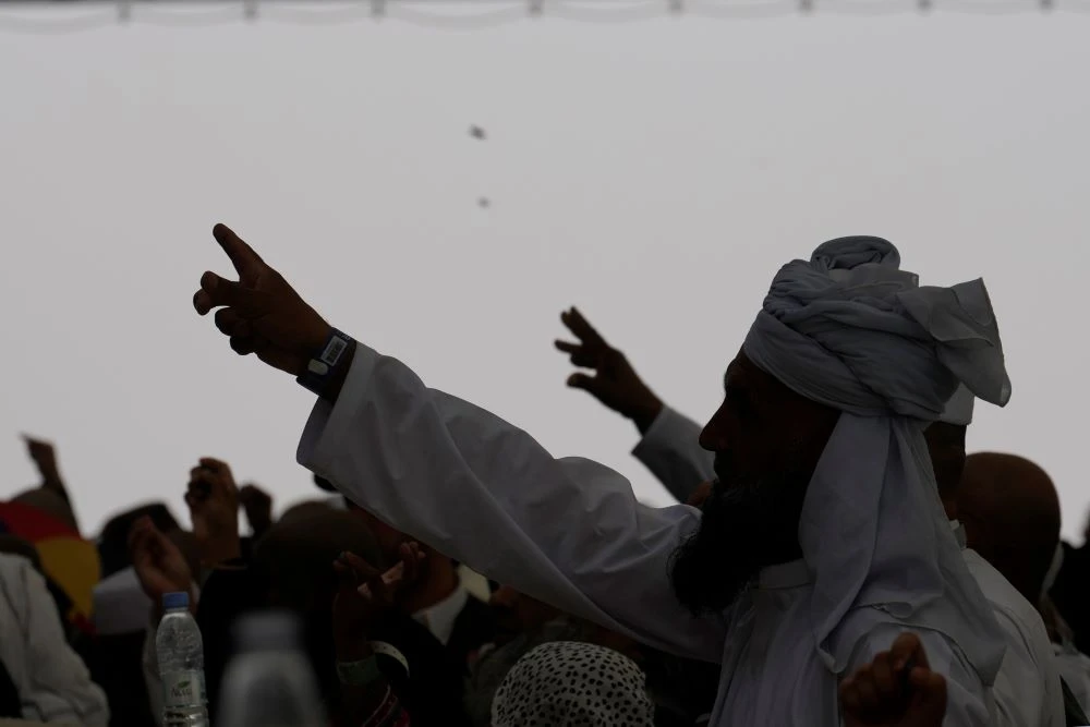 Muslim pilgrims cast stones at pillars in the symbolic stoning of the devil, the last rite of the annual Hajj, as it rains in Mina, near the holy city of Makkah, Saudi Arabia, Monday, June 17, 2024. (AP Photo)