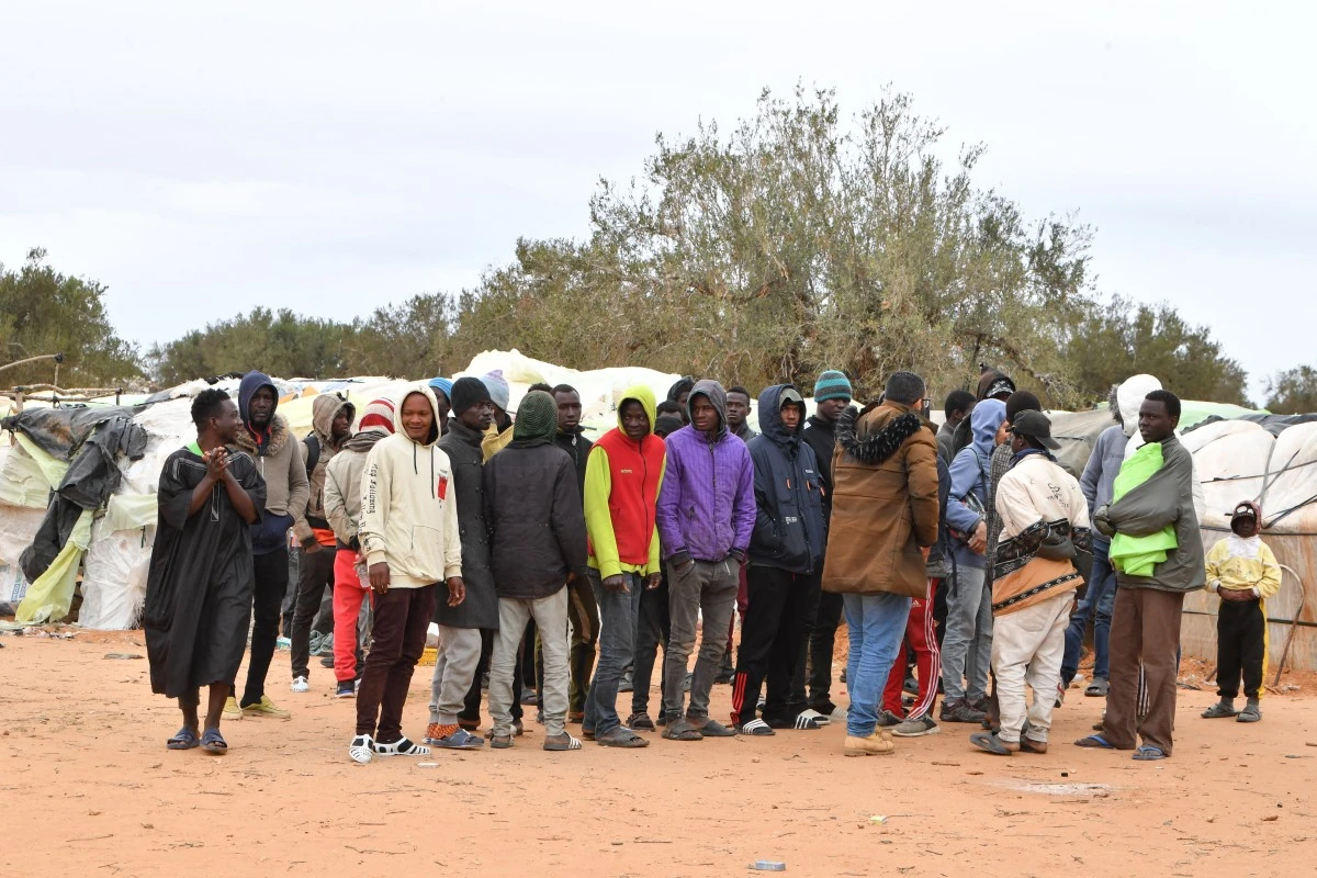 igrant from Sub-Saharian Africa gather gather near their tents at a camp in Jebeniana in Tunisia's Sfax governorate on April 24, 2024. (File/AFP)