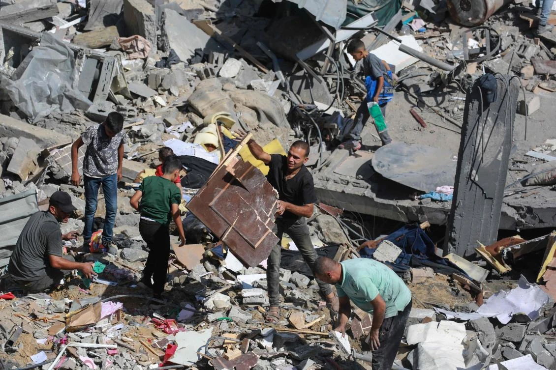 Palestinians search the rubble of house following overnight Israeli strikes in Al-Bureij refugee camp in the central Gaza Strip on June 18, 2024. (AFP)