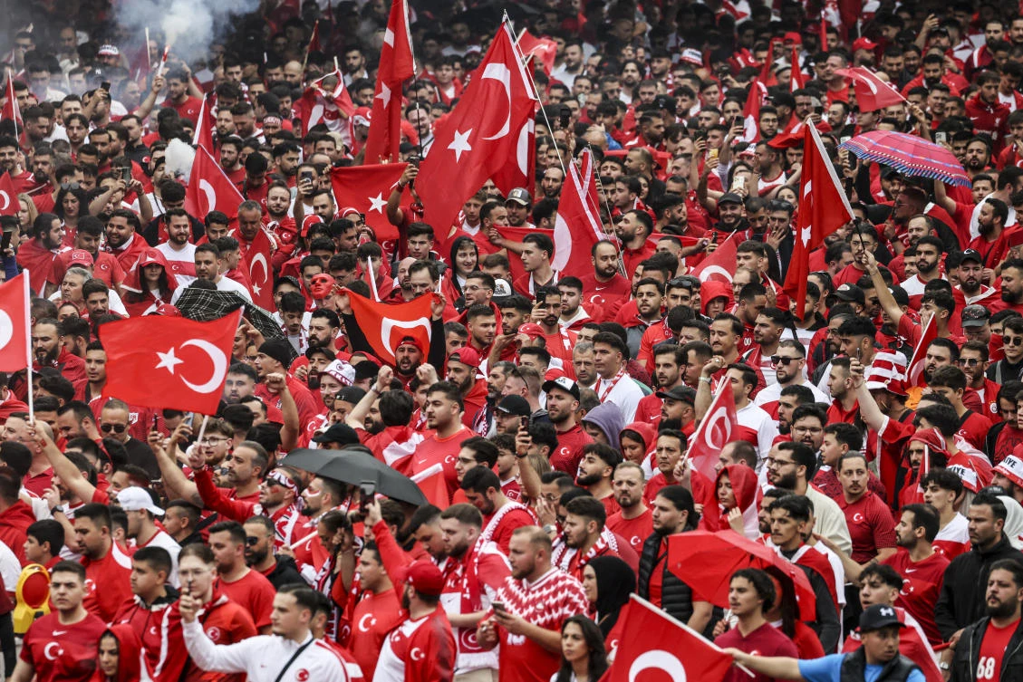 Turkish fans march toward the stadium ahead of a Euro 2024 Championship Group F match between Turkiye and Georgia, in Dortmund, on Jun. 18, 2024. (AP)