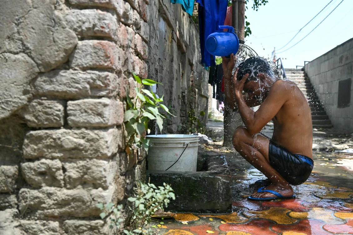 A man bathes on a hot summer day in New Delhi on June 18, 2024, amid heatwave. (AFP)